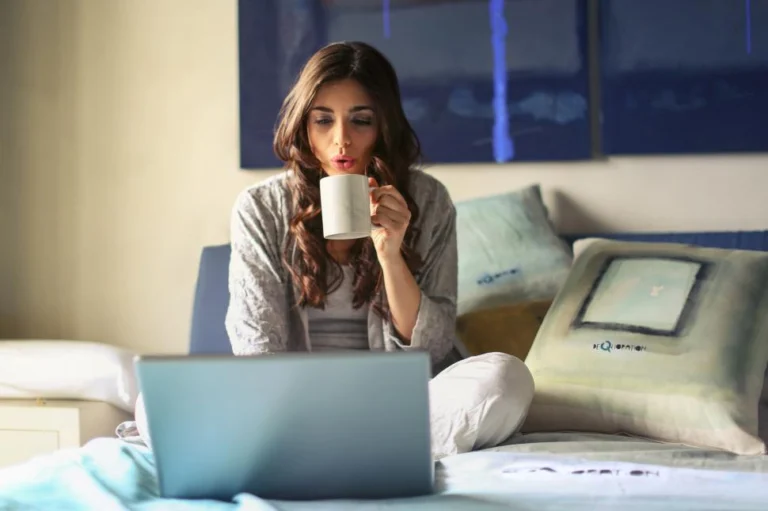 person relaxing with a cup of coffee after completing a successful workday from home